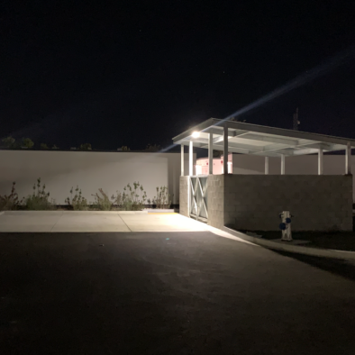 Solar LED wall pack light installed on commercial garage wall