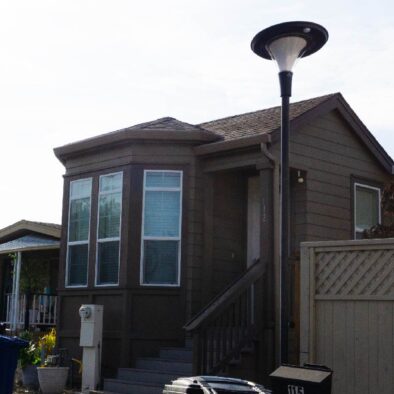 Decorative solar post top light in urban landscape